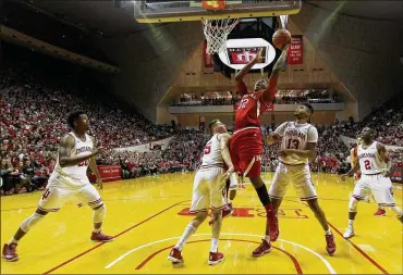  ?? DYLAN BUELL/GETTY IMAGES 2016 ?? Nebraska’s Jordy Tshimanga shoots over Indiana players in December 2016 in Bloomingto­n, Indiana. Tshimanga said he will use this season “to get better basketball-wise. That’s a big part of what I need right now.”