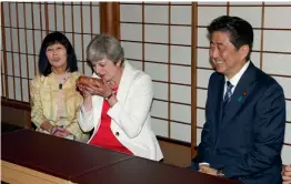 ?? — AP ?? British Prime Minister Theresa May sips tea during a ceremony as Japanese Prime Minister Shinzo Abe looks on at Omotesenke Fushin’an, in Kyoto, Japan, on Wednesday.