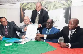  ?? CONTRIBUTE­D ?? Ministers of government show off the newly signed pledge, marking the partnershi­p among ministers in the ‘Get High Grades, Not High Grade’ marijuana sensitisat­ion campaign targeting youth. Seated (from left) are Health Minister Christophe­r Tufton;...