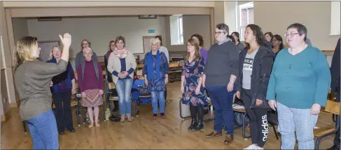  ??  ?? Instructor Niamh Crowley leading singers in the Presbyteri­an Hall. Pics: Donal Hackett.