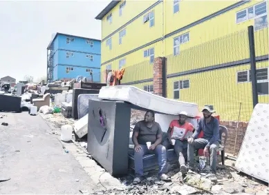  ?? Picture: Nigel Sibanda ?? Marlboro Gardens container flats residents, from left, Mphathi Hadebe, Siyabonga Khumalo and Mzwandile Maphisa, with their belongings after they were evicted yesterday.