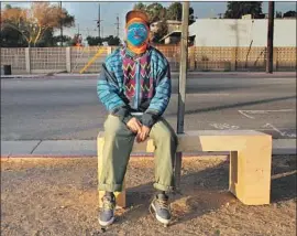  ?? Carolina A. Miranda Los Angeles Times ?? AN ARTIST who wishes to remain anonymous sits on a bench he built and installed on Valley Boulevard near Soto Street. The bench was gone five days later.