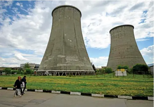  ?? ?? Employees walk near chimneys of Sofia Iztok thermal power plant on Thursday, a week after the halt of Russian gas supply to Bulgaria.
Agence France-presse