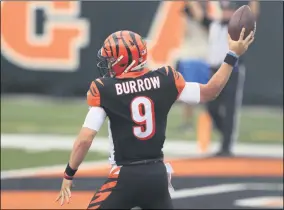  ?? AARON DOSTER - THE ASSOCIATED PRESS ?? Cincinnati Bengals quarterbac­k Joe Burrow (9) reacts after running for a touchdown during the first half of an NFL football game against the Los Angeles Chargers, Sunday, Sept. 13, 2020, in Cincinnati.