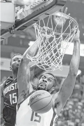  ?? Brett Coomer / Houston Chronicle ?? Jazz forward Derrick Favors scores on a dunk against Rockets center Clint Capela during the first half. Favors had 10 points on 5-for-7 shooting. Capela was 10-for-15 for 21 points with a team-high 11 rebounds.