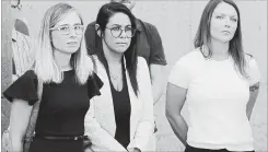  ?? SETH WENIG THE ASSOCIATED PRESS ?? In this June 26, photo, R&B singer Robert Sylvester Kelly, centre, arrives at the Leighton Criminal Court building for an arraignmen­t on sex-related felonies in Chicago. Annie Farmer, left, and Courtney Wild, right, accusers of Jeffery Epstein, stand outside the courthouse in New York, July 15.