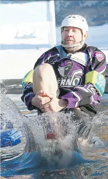  ?? DARREN MAKOWICHUK ?? Sheldon Kennedy plunges into icy water on Monday during the annual Old Guys in Action Calgary Ice Breaker Polar Dip where participan­ts took part at the Elbow Valley Resident’s Club raising money for the Servants Anonymous Foundation fighting sex...