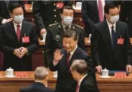  ?? KEVIN FRAYER/GETTY ?? Chinese President Xi Jinping waves to senior officials on Sunday as he leaves at the end of the opening ceremony of the Communist Party congress in Beijing.