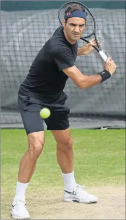  ??  ?? Roger Federer calienta sobre hierba en una foto de archivo.