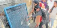  ?? PRAFUL GANGURDE ?? Students taking the HSC exams check their names and seat numbers at an exam centre in Thane.