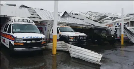  ?? The Associated Press ?? An awning came crashing down on rescue vehicles from the Emergency Management Agency in Humacao, Puerto Rico, on Wednesday.