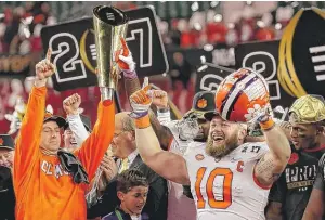  ?? | GETTY IMAGES ?? Coach Dabo Swinney and linebacker Ben Boulware lead the celebratio­n after Clemson’s victory Monday against Alabama in the College Football Playoff title game in Tampa, Fla.