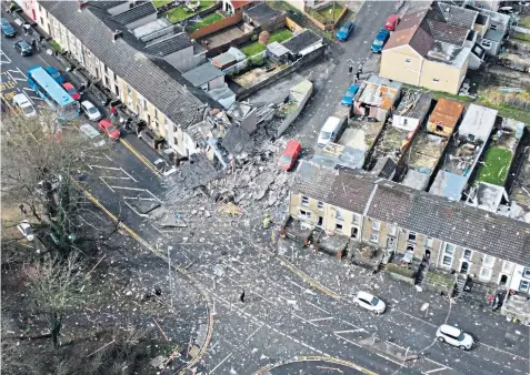 ?? ?? A drone photo shows one house destroyed, another badly damaged and debris strewn across the area after the explosion in Swansea, south Wales, yesterday