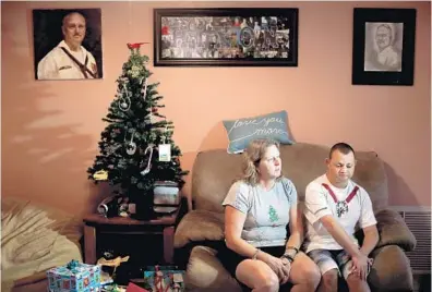  ?? MIKE STOCKER/SUN SENTINEL ?? Debbi Hixon sits in the living room of her Hollywood home next to a Christmas tree with her youngest son, Corey.