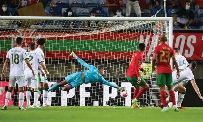  ?? Photograph: Stephen McCarthy/Sportsfile/Getty Images ?? Cristiano Ronaldo heads Portugal’s 89th-minute equaliser past the Republic of Ireland goalkeeper Gavin Bazunu.