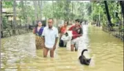  ?? PTI ?? Villagers move to a safer place from a flood-affected area after heavy rain, in Assam’s Nalbari district on Sunday.