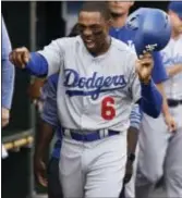  ?? LON HORWEDEL — THE ASSOCIATED PRESS ?? Dodgers outfielder Curtis Granderson celebrates in the dugout after scoring in the seventh inning against the Tigers Saturday in Detroit. Granderson was traded by the Mets to the Dodgers late Friday night.