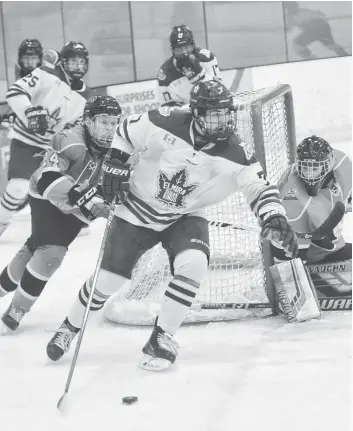  ?? [FAISAL ALI / THE OBSERVER] ?? Elmira’s Anthony Azzano circles around the net in a Nov. 25 game at the WMC against the visiting Listowel Cyclones. Azzano’s power-play goal late in the third put the Kings ahead for the first time, pacing the team to a 7-5 win.