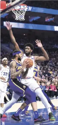  ??  ?? Defensa. Joel Embiid, de Filadelfia, protege el canasto mientras Brandon Ingram, de los Lakers, realiza una gestión ofensiva.