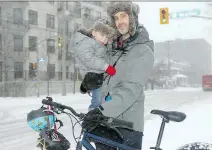  ?? JULIE OLIVER ?? David Weatherall, seen with his son and cycling partner, Felix, 2, is among a growing number of cyclists worried about the new plan for a bike lane on McArthur Avenue.