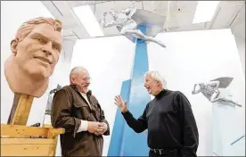  ?? LISA DEJONG / THE PLAIN DEALER ?? Sculptor David Deming (left) and Howard “Hutch” Stoller stand next to the prototypes of the new Superman statue inside Deming’s studio in 2015.