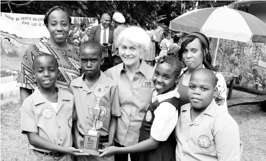  ?? CONTRIBUTE­D PHOTOS ?? George Headley Primary School shows off their trophy. From left: Kawaine Beaumont, Glendon Whyte, Carissa Beaumont, and Ricardo Richards, students from the school. Sharing in the moment are (back row, from left) Sonikay Beaumont, 4H leader and teacher at the school; Professor Elizabeth Ward, chair of the VPA; and Suzan Hart, Environmen­tal Club president and art teacher at the school.