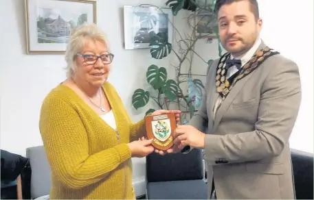  ??  ?? Lynda Gray, the warden of Evergreen Hall in Angel Street, Bridgend, was honoured for 20 years of service by Bridgend Mayor Stuart Baldwin.