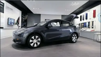  ?? CARLOS OSORIO/AP ?? A TESLA MODEL Y LONG RANGE is displayed on Feb. 24, 2021, at the Tesla Gallery in Troy, Mich.