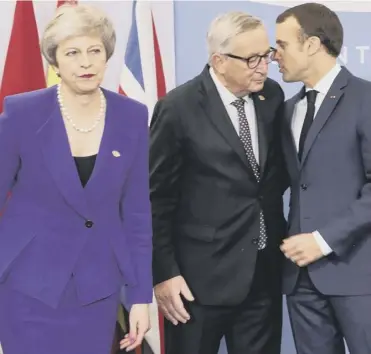  ??  ?? Theresa May walks past Emmanuel Macron and Jean Claude Juncker in Buenos Aires