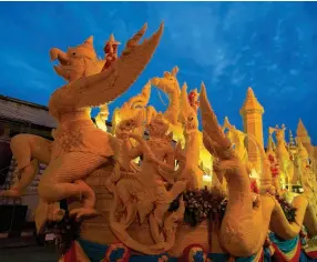  ??  ?? From left: Ubon Ratchathan­i Candle Procession;
Procession through the fire at the Phuket Vegetarian Festival.