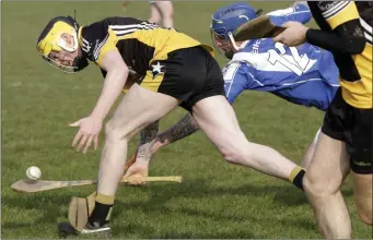  ??  ?? Ballygarre­tt midfielder Cormac Moore feels the heat from Danny Nolan of Eire Og.