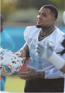  ?? AP PHOTO ?? TOUGH TOPIC: Dolphins center Mike Pouncey gets ready for practice yesterday. Pouncey spoke for the first time about the death of friend Aaron Hernandez.