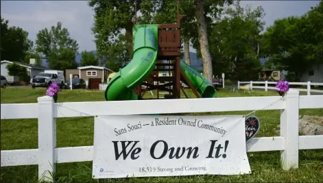  ?? / Staff Photograph­er
Matthew Jonas ?? A sign reading "We Own It!" is seen near the playground at the Sans Souci mobile home community July 13, 2021, in Boulder. New laws signed by Gov. Jared Polis will help other mobile home communitie­s to buy their parks, too.