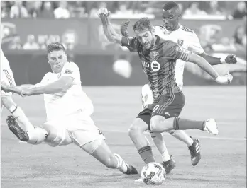  ?? THE CANADIAN PRESS/GRAHAM HUGHES ?? Montreal Impact's Ignacio Piatti, centre, breaks away from Real Salt Lake's David Horst, left, and Sunday Stephen during second half MLS soccer action in Montreal, Saturday, August 19, 2017.