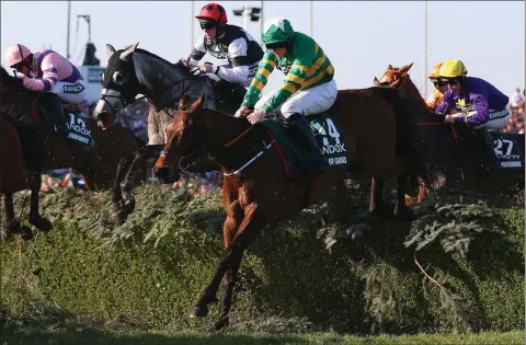  ??  ?? Cause of causes ridden by Jamie Codd clears the Water Jump during Saturday’s Grand National at Aintree.