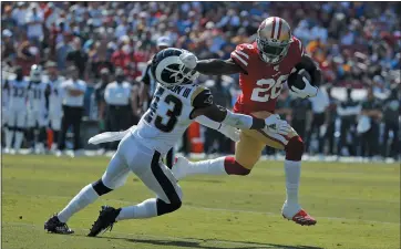  ?? JOHN LOCHER – THE ASSOCIATED PRESS ?? 49ers running back Tevin Coleman, right, used a strong right-handed stiff arm as he ran around Rams strong safety John Johnson to score a crucial touchdown. The big play capped a 75-yard, 10-play drive and pulled the 49ers event at 7.