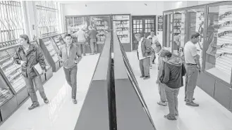  ?? Ni ck Wagner photos / Associated Press ?? Customers shop at Mexico’s lone gun store in Mexico City. The store sold 549 guns in 2000, but sales rose to over 10,000 guns in 2015, an increase reflecting the rise in concern about personal safety.