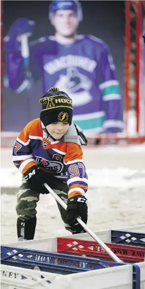  ?? LARRY WONG ?? Jaxon Kalmbach, 7, plays a game at the Rogers Hometown Hockey Tour, held outside the Sherwood Park Arena and Sports Centre Jan. 5 and 6. The free hockey celebratio­n featured live entertainm­ent and appearance­s by NHL alumni including Glenn Anderson and Grant Fuhr.