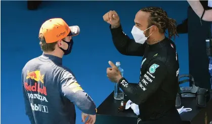  ?? (AFP) ?? Mercedes' British driver Lewis Hamilton (R) talks with Red Bull's Dutch driver Max Verstappen after the qualifying session at the Circuit de Catalunya in Barcelona on Saturday