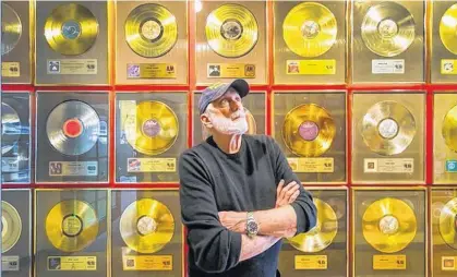  ?? ARLEN REDEKOP ?? Bruce Allen poses in front of a wall of gold records at his office in Vancouver May 12.