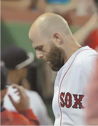  ?? STAFF PHOTO BY JOHN WILCOX ?? FEELING LOW: Dustin Pedroia walks off the field after the Red Sox’ 16-inning loss to the New York Yankees last night at Fenway Park.