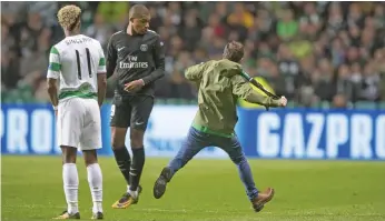  ?? Getty Images ?? The Celtic fan who ran at Kylian Mbappe, centre, was quickly subdued by stewards