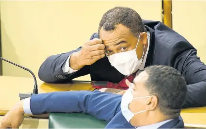  ?? FILE ?? Prime Minister Andrew Holness (front) engages Dr Christophe­r Tufton, the Minister of Health and Wellness, during a sitting of the House of Representa­tives.