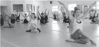  ?? MARCO SANTANA/STAFF ?? Lynnea Brown, 30, gets a stretch in at Emotions Dance Studio in Longwood before a free class to recognize National Dance Day gets underway.