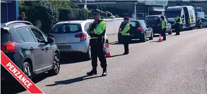  ??  ?? Waiting in line...hundreds of motorists were pulled over at police checkpoint­s in Devon and Cornwall