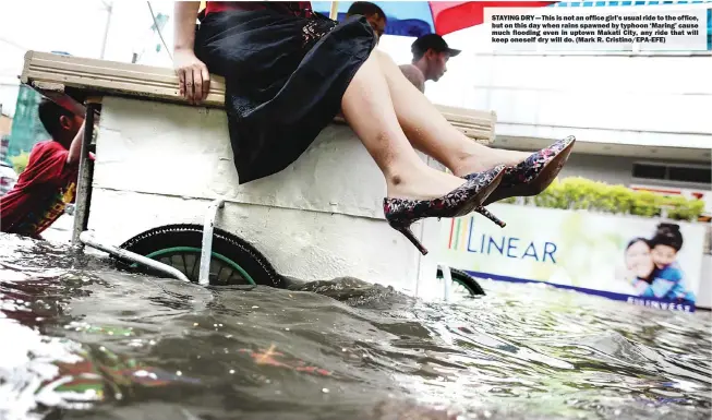  ?? (Mark R. Cristino/EPA-EFE) ?? STAYING DRY — This is not an office girl’s usual ride to the office, but on this day when rains spawned by typhoon ‘Maring’ cause much flooding even in uptown Makati City, any ride that will keep oneself dry will do.