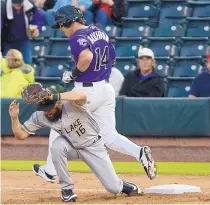  ?? ADOLPHE PIERRE-LOUIS/ JOURNAL ?? Albuquerqu­e’s Mike Tauchman (14) reaches on an infield hit during the Isotopes’ win over Salt Lake Monday.