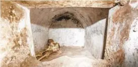  ?? AP ?? Nearly 2,000-year-old skeleton rests in tomb in the necropolis of Porta Sarno, an area not yet open to the public in the east of Pompeii’s center.