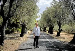  ?? ?? NATURE Hadlock poses for a photo on a road lined with olive trees near his workplace in Lisbon.