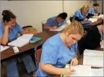  ?? DIGITAL FIRST MEDIA FILE PHOTO ?? Antonelli Medical & Profession­al Institute has announced that is plans to close at the end of the year. In this 2016 file photo, medical assistant students work in a classroom at Antonelli Medical & Profession­al Institute.